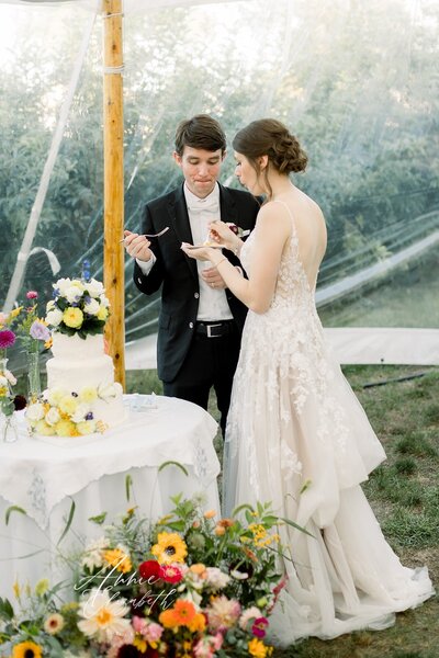 Couple eating their wedding cake at wedding