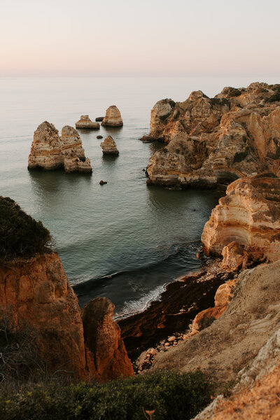 Stunning beaches in Lagos, Portugal at sunrise that would make the perfect location to read vows during an elopement.