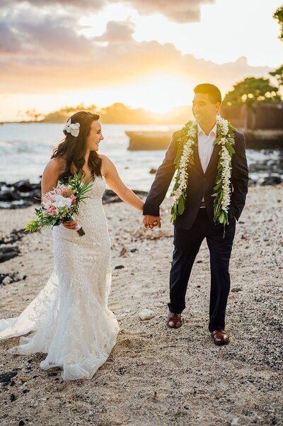 Couple Walking at sunset during their Big Island wedding