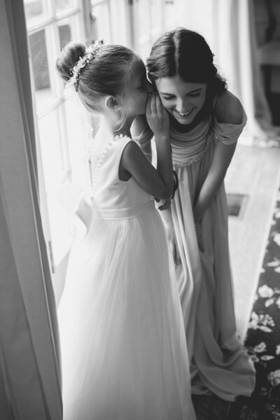 A bride smiles while being getting ready.