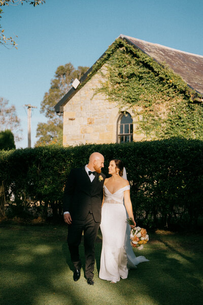 A couple walking and smiling at their wedding in the Hunter Valley