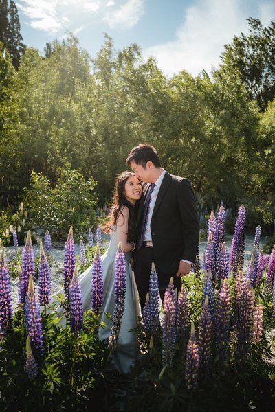 Man and Woman hugging surrounded by purple lupins