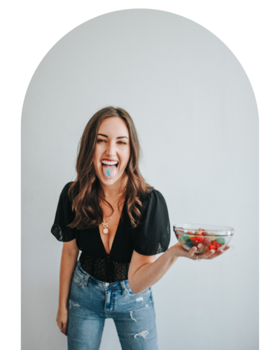 woman sticking tongue out and holding a bowl of candy