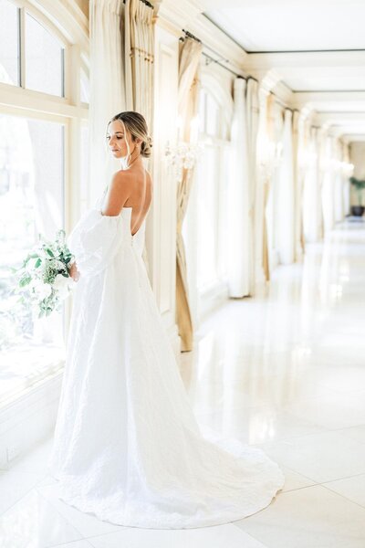 All white wedding decorations, white floral centerpieces and large white wedding cake