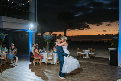 bride and groom kissing and dancing at wedding reception