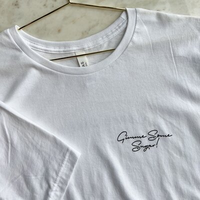 White t-shirt with "Gimme Some Sugar!" Printed on the left hand side in black