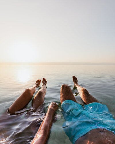 man and woman floating in ocean