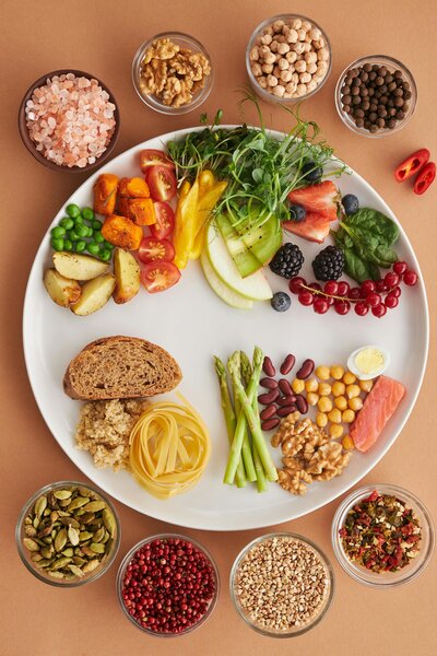 A plate of rainbow colored whole food for eating across the rainbow