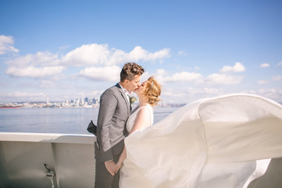 Bride and groom kissing on Bremerton Ferry to Seattle
