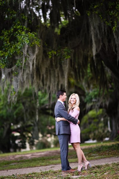 Beautiful engagement Photography: Couple in front of oaks with Spanish moss in Biloxi, Mississippi, Mississippi Photographer