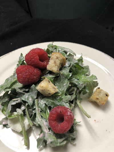 Gourmet salad with croutons and raspberries