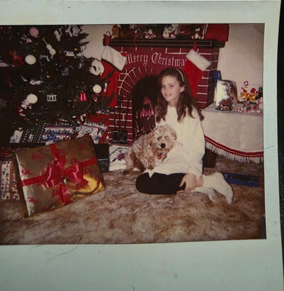 April in front of her favorite cardboard vintage fireplace in the 1980s in her parents living room Kansas City Missouri 