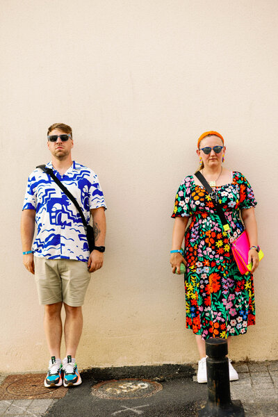 Husband and wife dressed colourfully having their own picture taken by their daughter in France