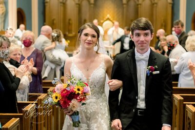 Couple leaving church together after their wedding ceremony - UME (New England Wedding Planners help with wedding day)