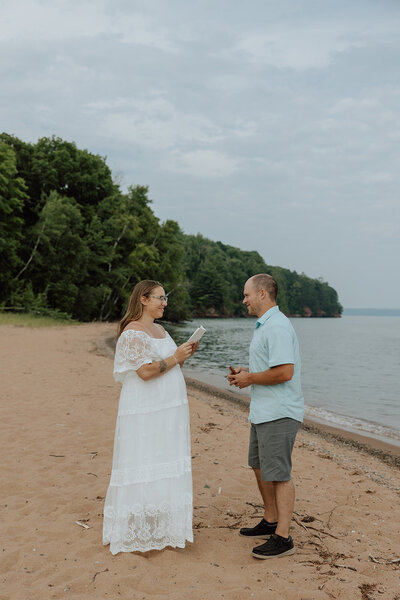 Bride and groom saying vows on a beach at the apostle islands, WI. Photo taken by a Wisconsin elopement photographer