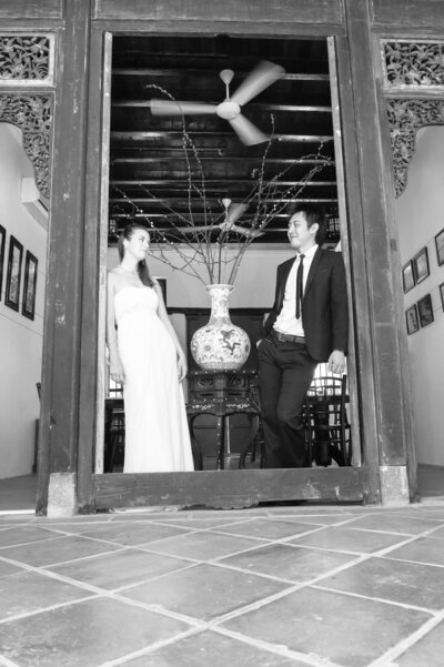 Bride and groom stand in a doorway