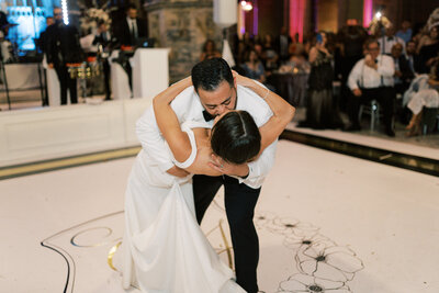 A bride and groom share a fun kiss on the dance floor in Cleveland Ohio