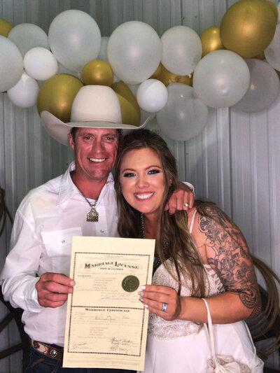 A couple holding their marriage license