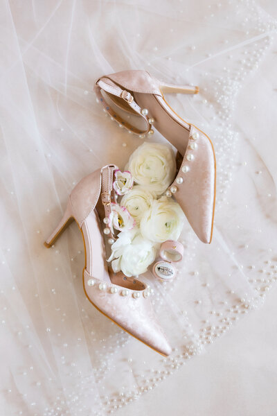 Detail photo of pink, printed wedding shoes with florals and wedding rings by Angelika Krug Photo & Film 