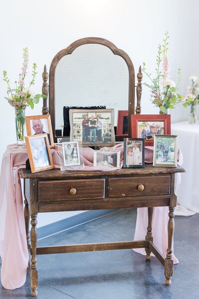 Vintage table with photos at wedding reception at The Highlands in Valley Center, Kansas