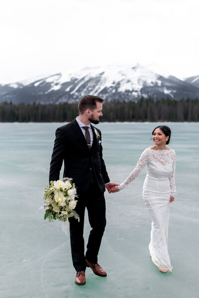 Adventurous bride and groom on ice covered lake, featured on Bronte Bride, an online Canadian wedding publication and resource.