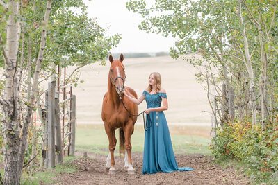 grad picture of a girl with a horse in a forest pathway