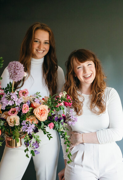 Mary Love and Mackenzie of Rosemary and Finch wedding floral designers, florists, in Nashville, TN. Specialize in large scale weddings, installation, travel weddings, beach, mountain. Floral hues of purple, magenta, and natural greenery.