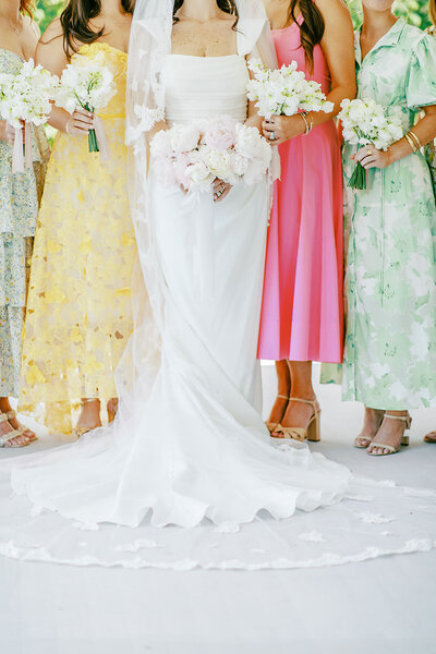 Bride stands with her bridesmaids