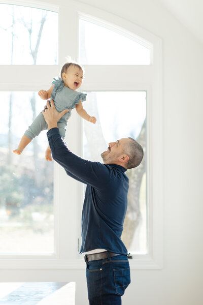 Dad throws baby in the air