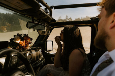 adventure bride putting on lipstick while eloping on the Oregon Coast