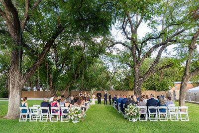 Outdoor ceremony location under beautiful trees at Hotel Lucy in Granbury Texas