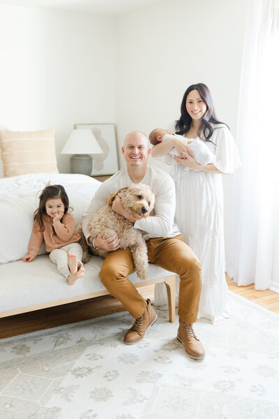 Young family pose for newborn portrait at their Philadelphia home