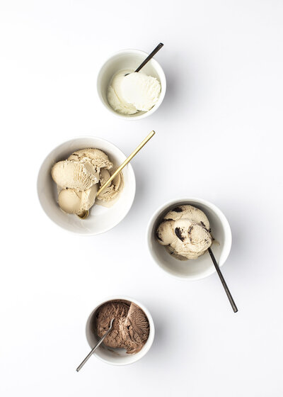Ice cream varieties in bowls on white table