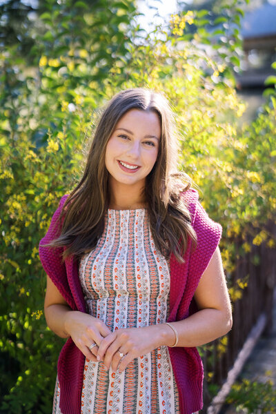 Allison sitting on chair holding baby bump