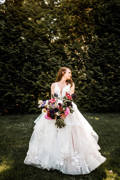 bride in beautiful dress with colorful bouquet captured by cleveland wedding photographers three and eight