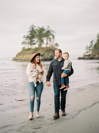 Family walk along stony beach in Seattle Washington photographed by Seattle film photographer Magnolia Tree Photo Company