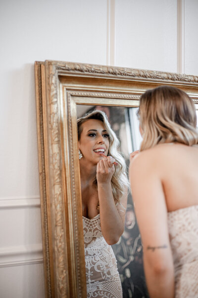 Bridal makeup artist applies soft glam makeup for a radiant wedding day look.