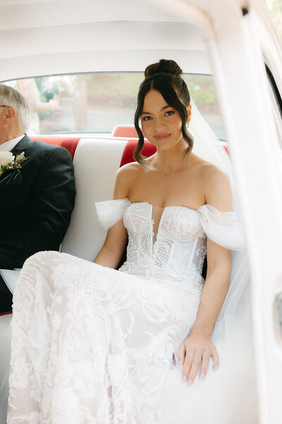 Bride in back of car.