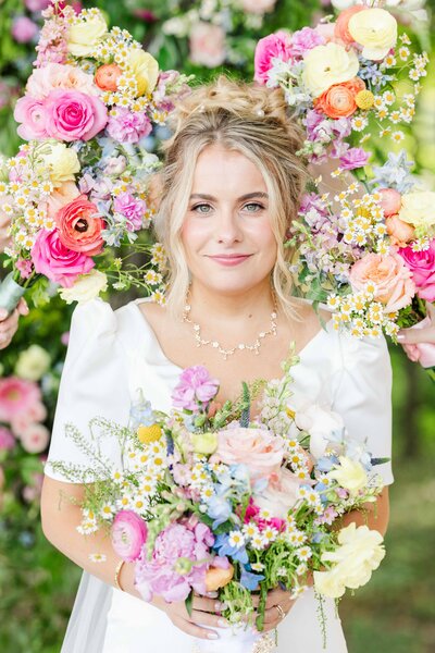 Bright, bridal bouquets surrounding brides face on her wedding day!