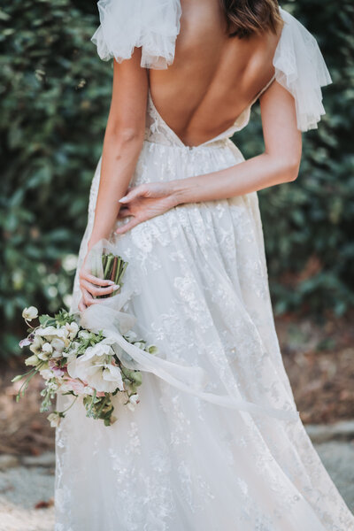 bride holding bouquet behind her back