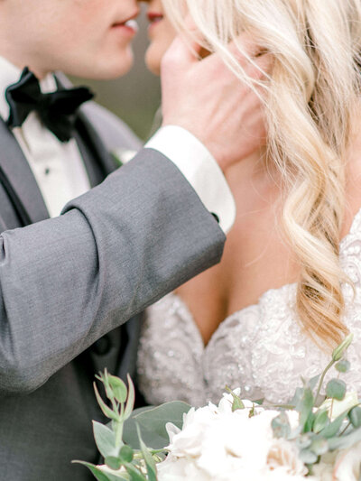 Bride and groom embrace for a kiss
