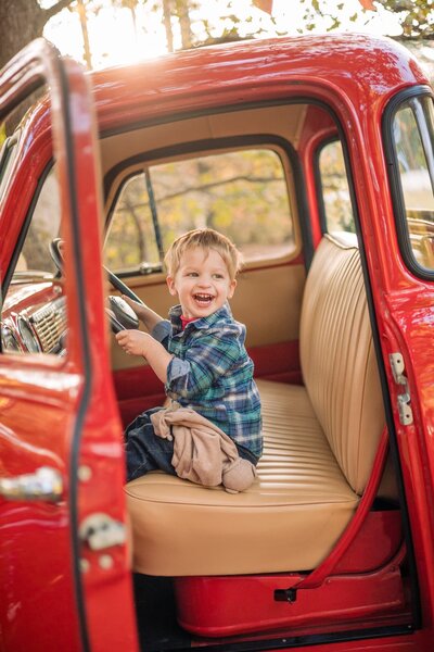 Little boy in red truck
