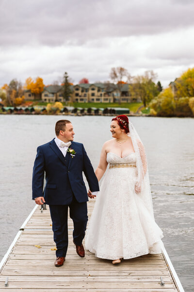 Bride and groom holding hands on the dock - Walker, Minnesota
