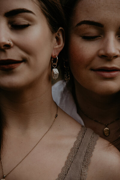 two girls wearing clay earrings