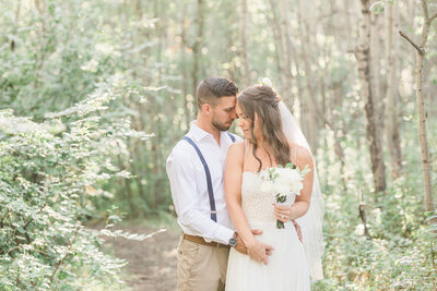 Bride and Groom embracing in forest, captured by Jennifer Chabot Photography, classic and romantic wedding photographer in Calgary,  Alberta. Featured on the Bronte Bride Vendor Guide.