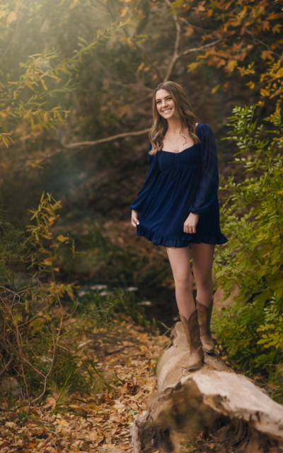 girl n cowboy boots at her senior portrait session in los angeles