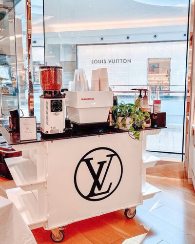 Quigley Coffee Co cart serving espresso drinks at a Louis Vuitton store event, highlighting luxury coffee catering for retail activations.