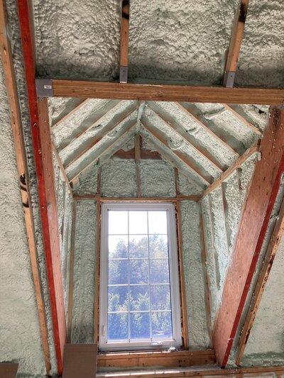 Spray foam insulation installed in ceiling and around window