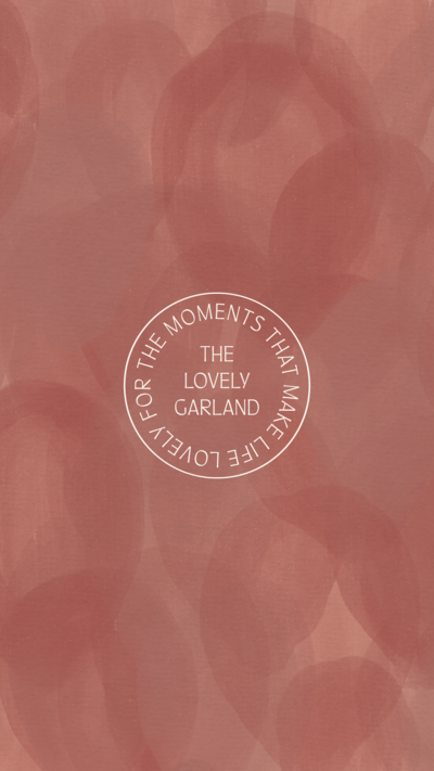 The Lovely Garland stamp logo on pink abstract texture background