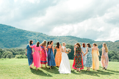 Bride walks through North Carolina hills with her bridesmaids
